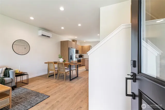 a view of a room with furniture and wooden floor