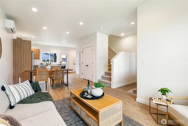 a living room with furniture kitchen and a table