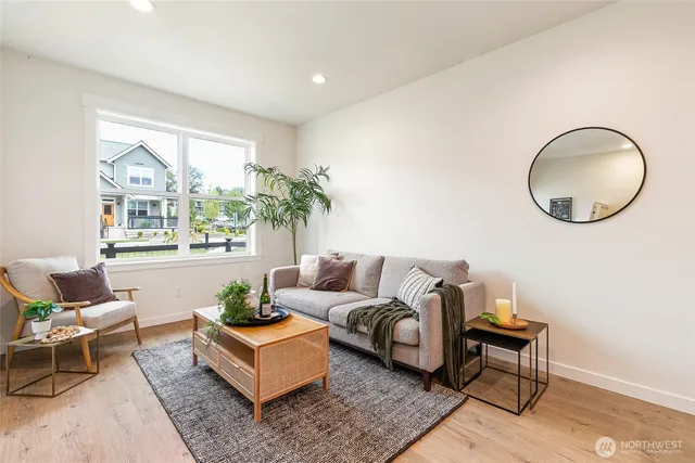 a living room with furniture a lamp a rug and a large window