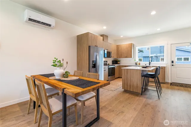 a view of a dining room with furniture and wooden floor
