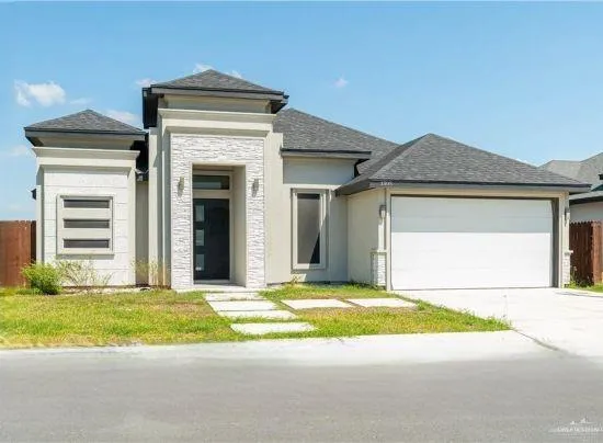 a view of a house with a small yard and large window