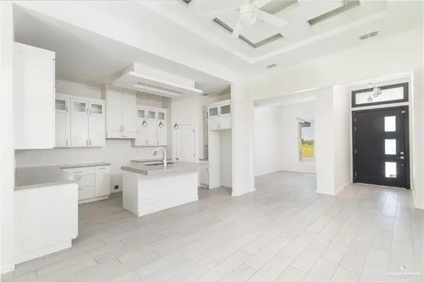 a view of a kitchen with refrigerator and windows
