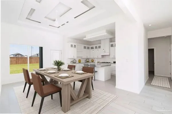 a view of a dining room with furniture and a kitchen