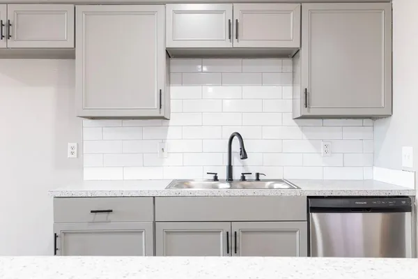 a kitchen with cabinets appliances and a sink