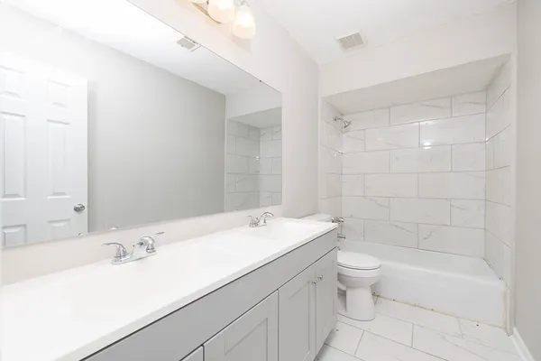 a bathroom with a sink a toilet and bathtub