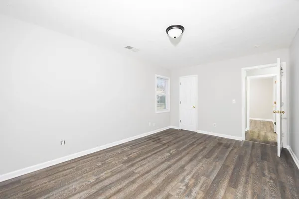 a view of a room with wooden floor