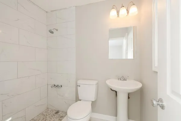 a bathroom with a sink toilet and shower