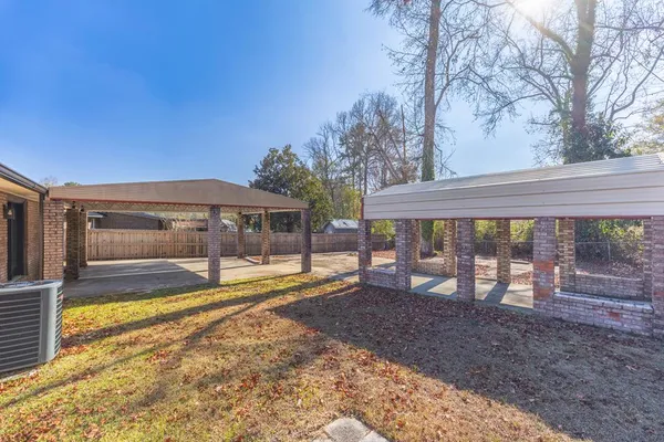a view of a house with backyard and sitting area