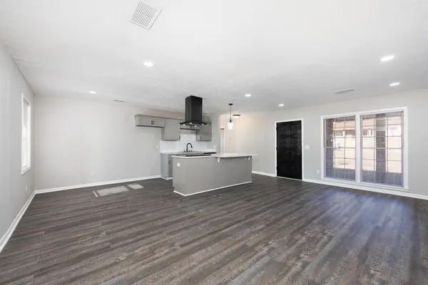 a view of kitchen with refrigerator and window