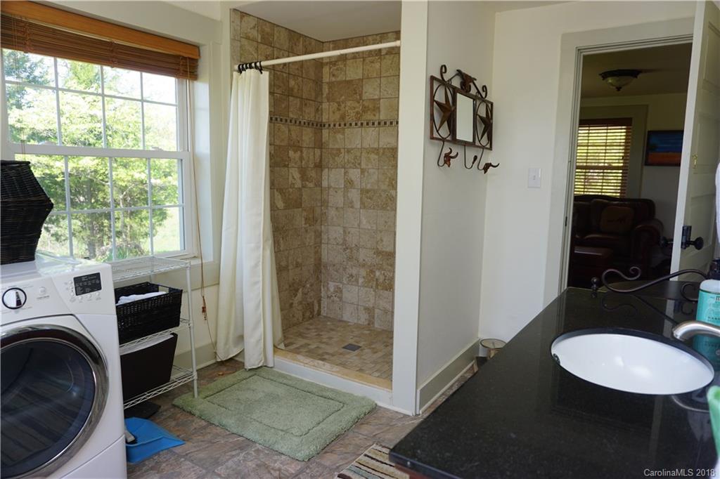2290 Red Fox Road Tryon, NC 28782 - Photo 14 of 36 a bathroom with a granite countertop sink mirror vanity and window