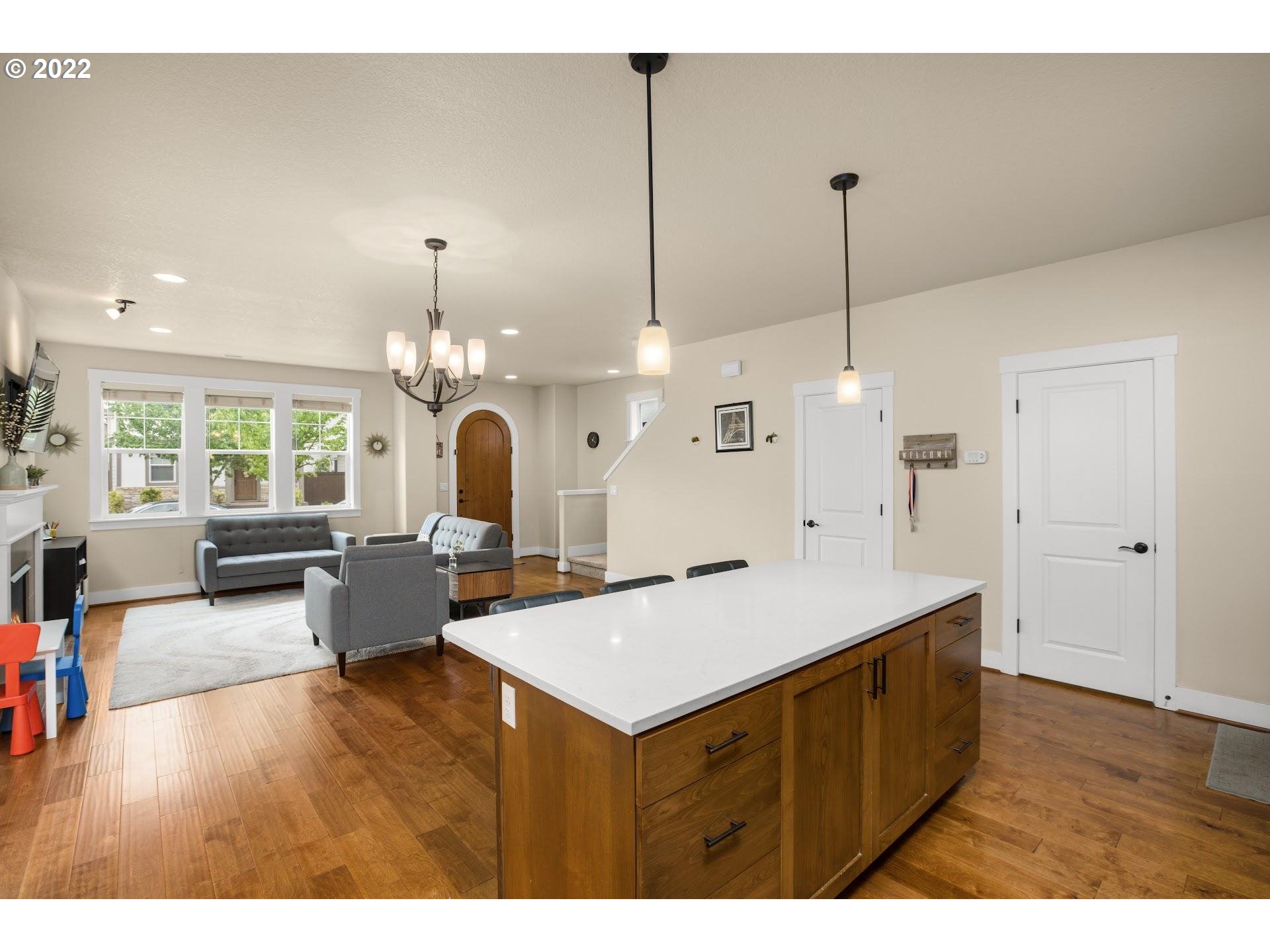 374 Southwest 202nd Terrace Beaverton, OR 97006 - Photo 12 of 28 a living room with furniture and a chandelier