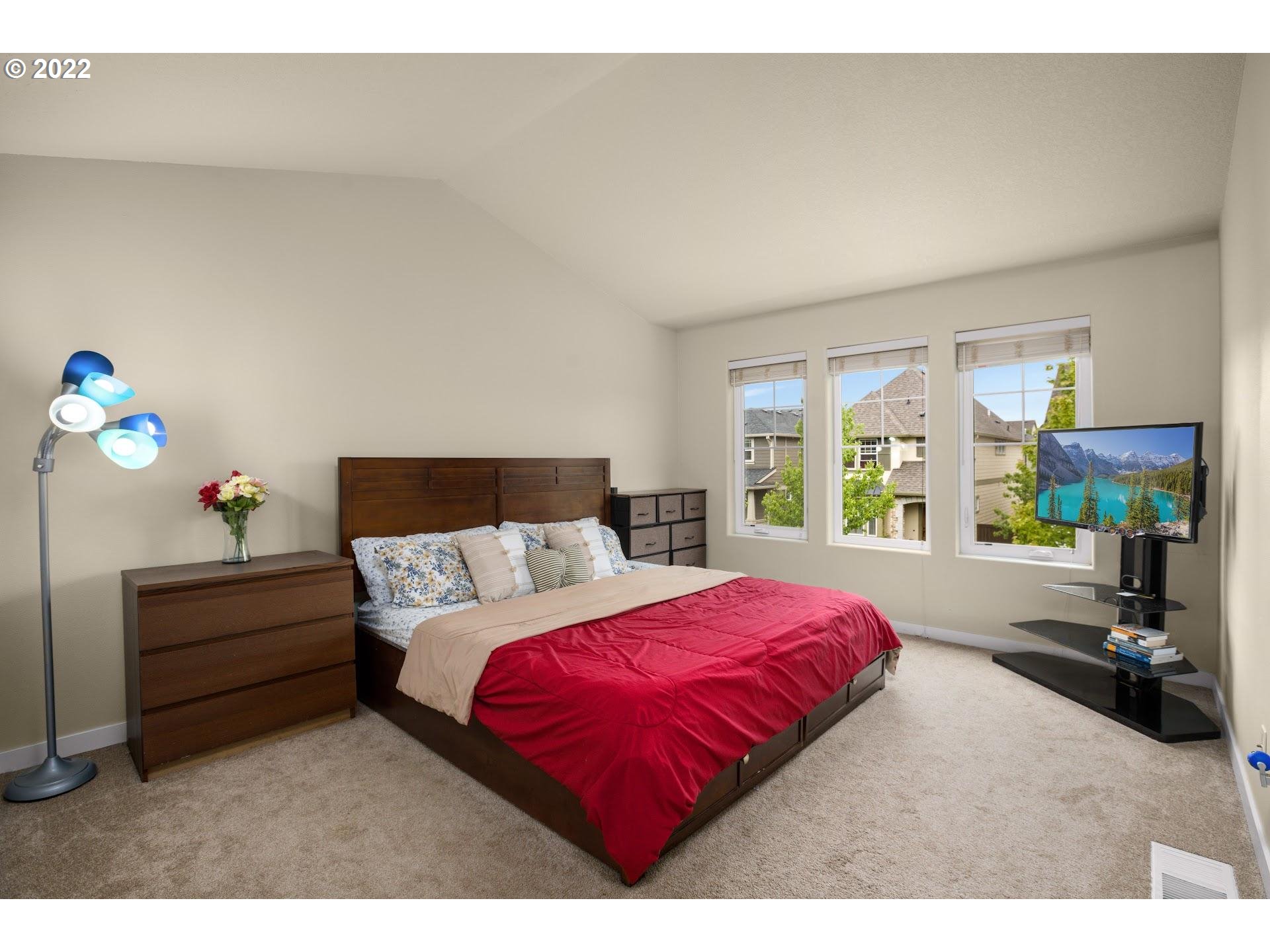 374 Southwest 202nd Terrace Beaverton, OR 97006 - Photo 13 of 28 a bedroom with a bed and a large window