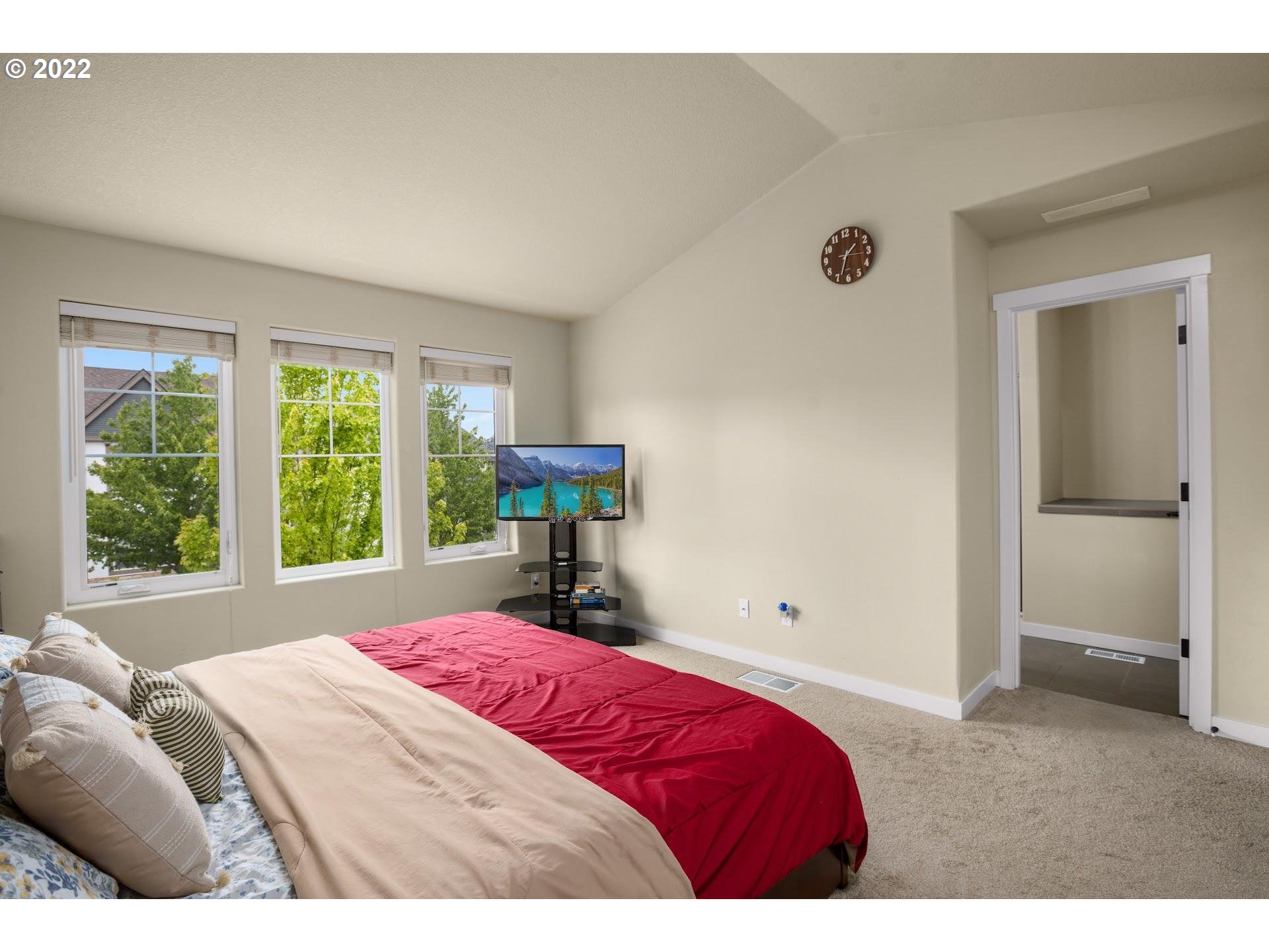 374 Southwest 202nd Terrace Beaverton, OR 97006 - Photo 14 of 28 a bedroom with a bed and a window