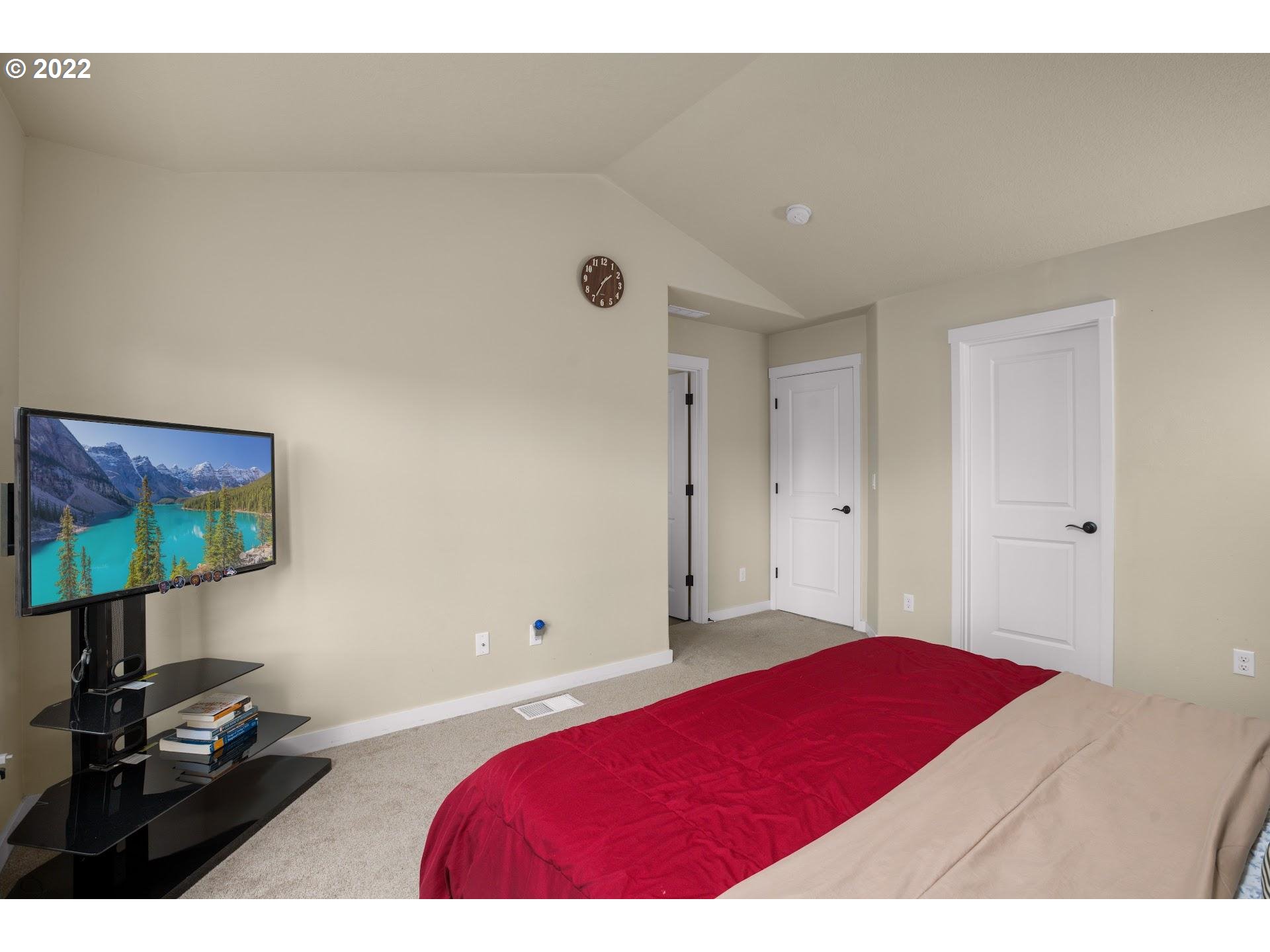 374 Southwest 202nd Terrace Beaverton, OR 97006 - Photo 15 of 28 a bedroom with a bed and a flat screen tv
