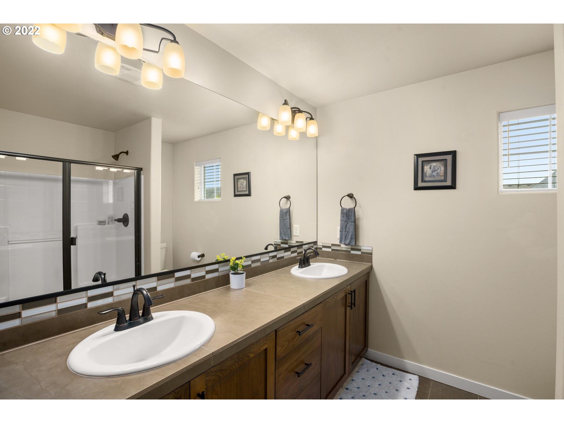 374 Southwest 202nd Terrace Beaverton, OR 97006 - Photo 16 of 28 a bathroom with a sink and a mirror