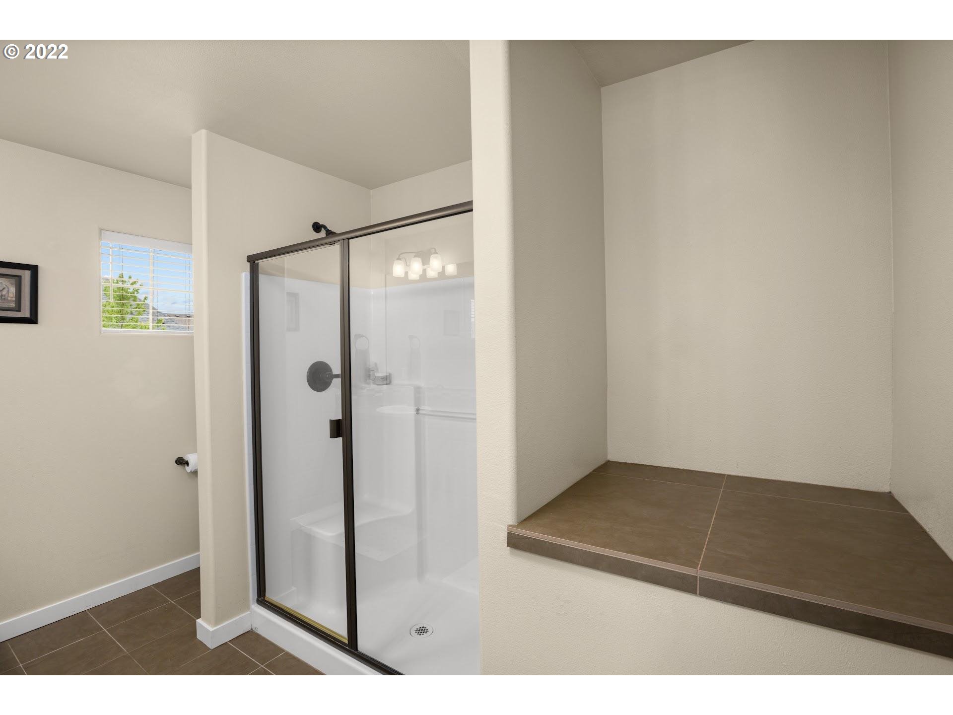 374 Southwest 202nd Terrace Beaverton, OR 97006 - Photo 17 of 28 a view of a bathroom with a glass door