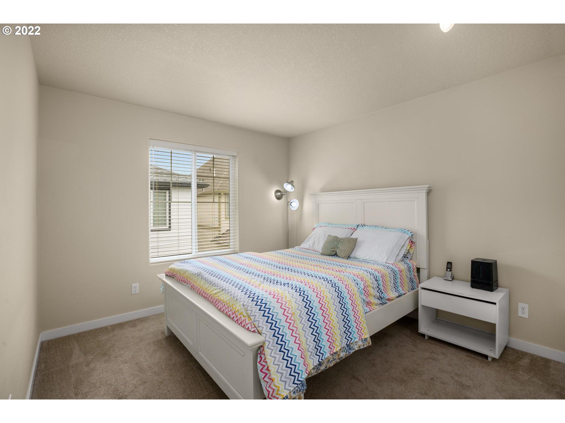 374 Southwest 202nd Terrace Beaverton, OR 97006 - Photo 19 of 28 a bedroom with a bed and a window