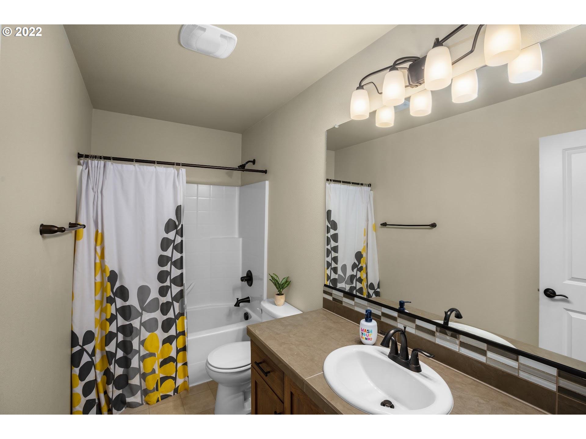 374 Southwest 202nd Terrace Beaverton, OR 97006 - Photo 20 of 28 a bathroom with a sink double vanity and a mirror