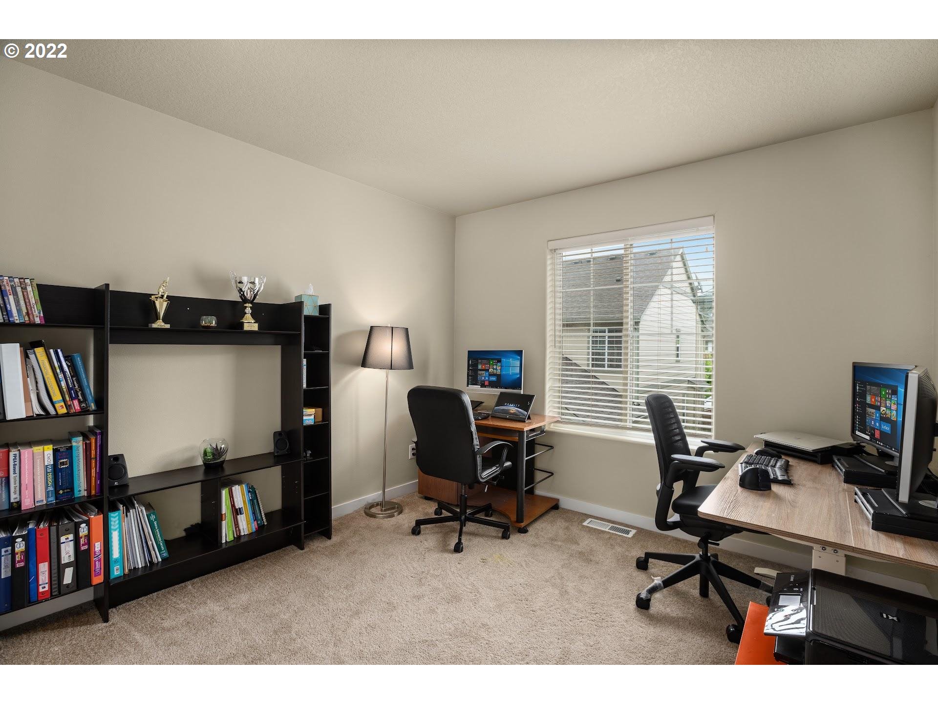 374 Southwest 202nd Terrace Beaverton, OR 97006 - Photo 22 of 28 a view of a workspace with furniture and a bookshelf