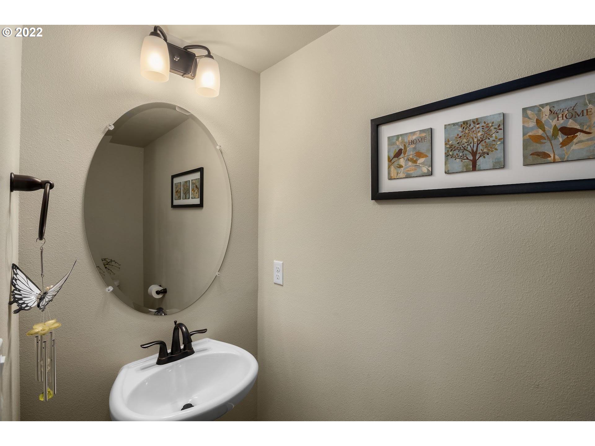 374 Southwest 202nd Terrace Beaverton, OR 97006 - Photo 23 of 28 a bathroom with a sink and mirror
