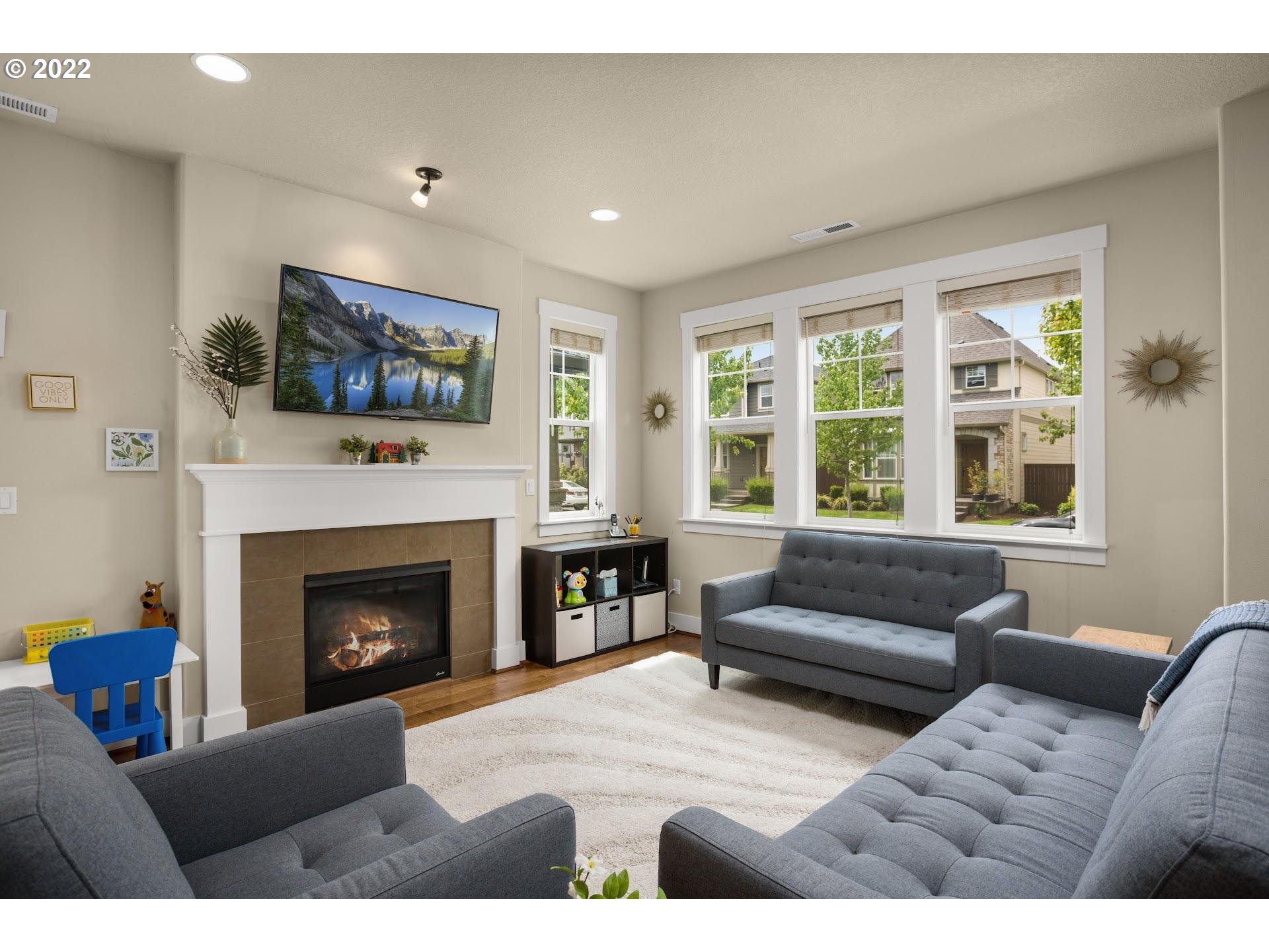 374 Southwest 202nd Terrace Beaverton, OR 97006 - Photo 5 of 28 a living room with furniture and a fireplace