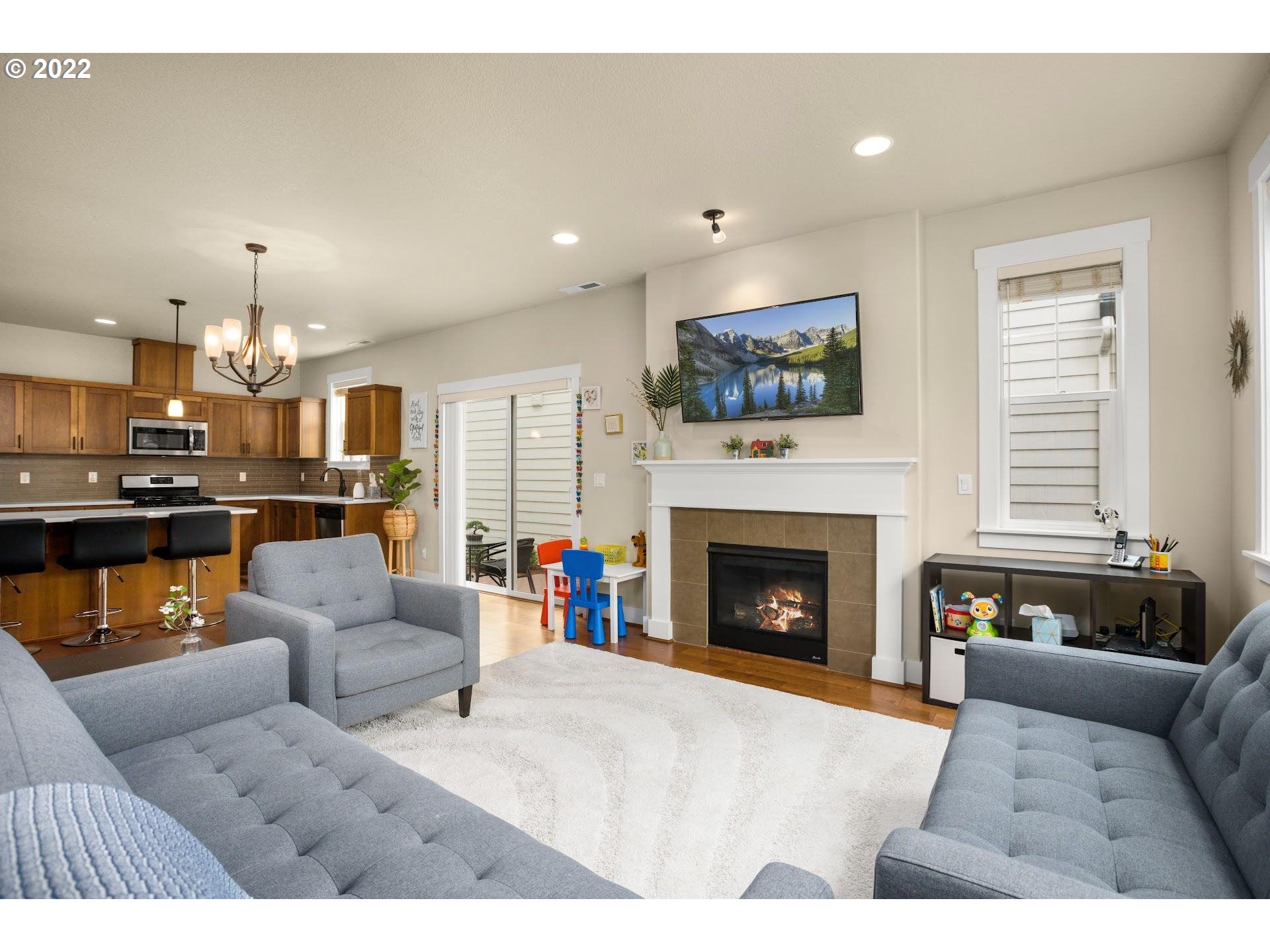 374 Southwest 202nd Terrace Beaverton, OR 97006 - Photo 6 of 28 a living room with furniture and a fireplace