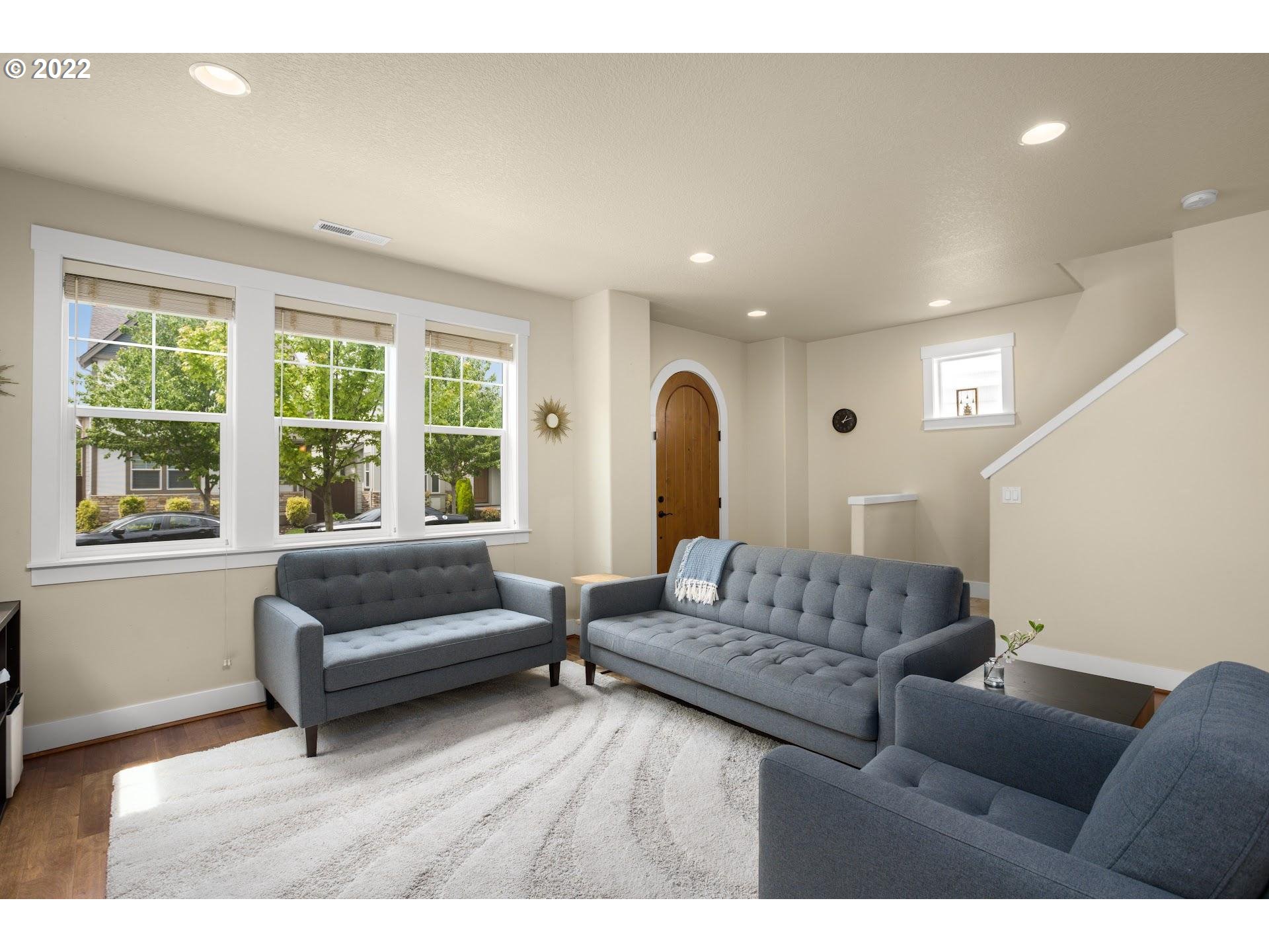 374 Southwest 202nd Terrace Beaverton, OR 97006 - Photo 7 of 28 a living room with furniture and a large window