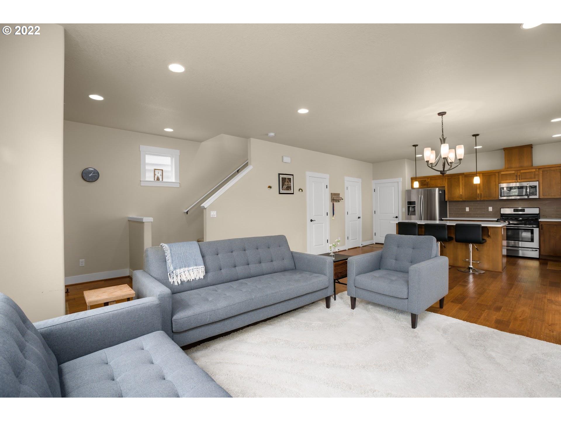 374 Southwest 202nd Terrace Beaverton, OR 97006 - Photo 8 of 28 a living room with furniture and kitchen view