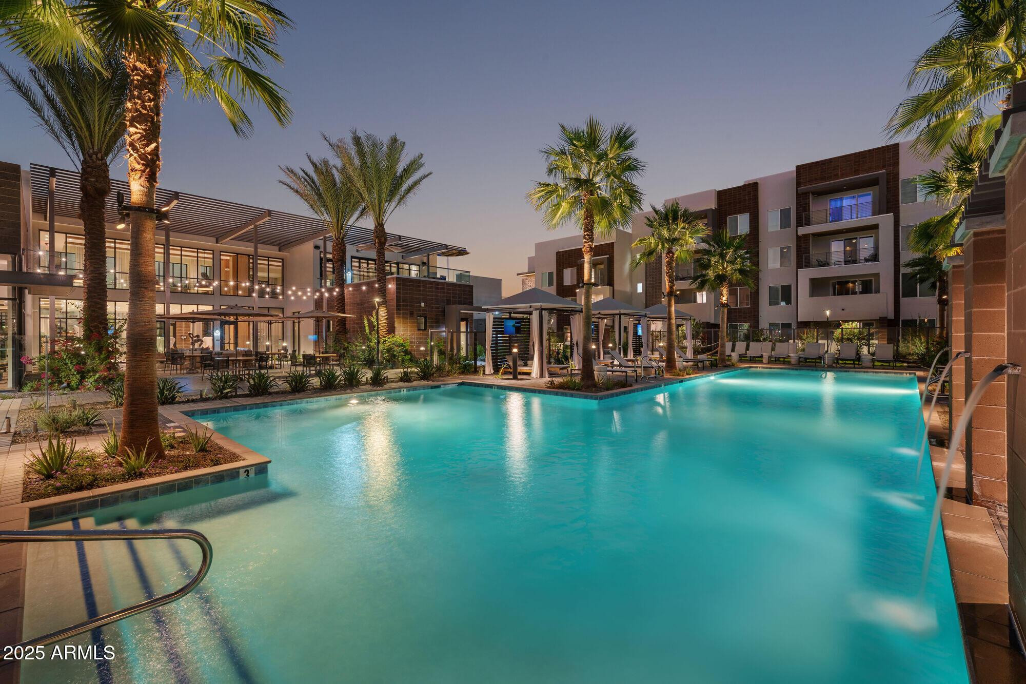 a view of swimming pool with outdoor seating and lake view