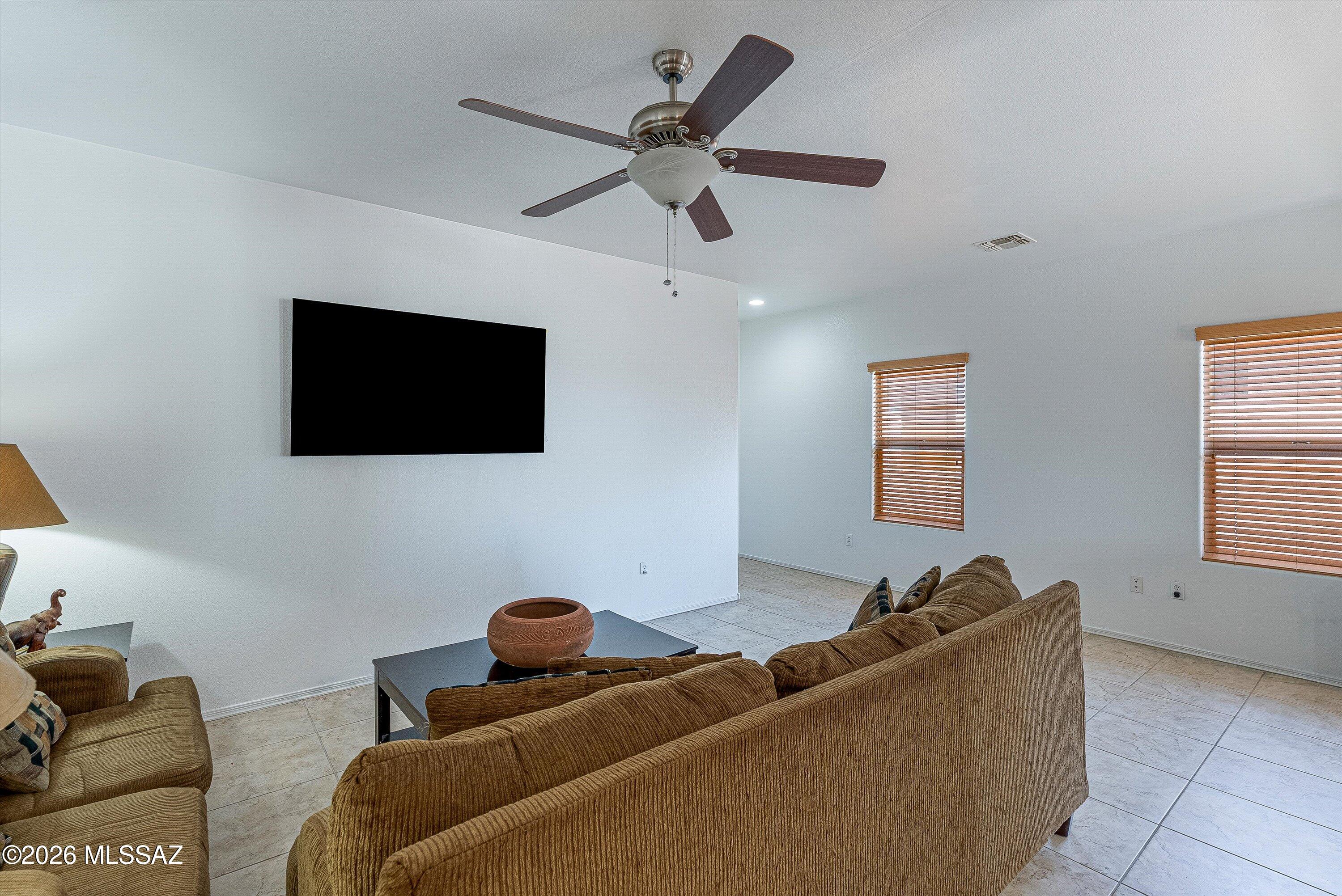 21163 East Treasure Road Red Rock, AZ 85145 - Photo 6 of 35 a living room with furniture and a flat screen tv