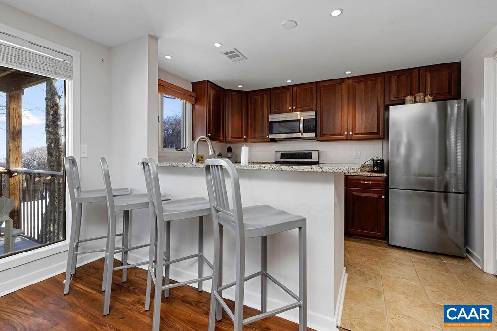 105 Eagles Court Wintergreen, VA 22967 - Photo 12 of 47 a kitchen with stainless steel appliances granite countertop a refrigerator and a stove top oven