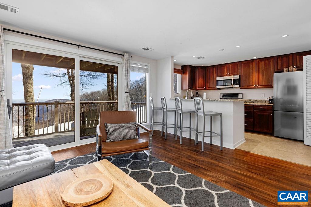105 Eagles Court Wintergreen, VA 22967 - Photo 4 of 47 a living room with furniture and a floor to ceiling window