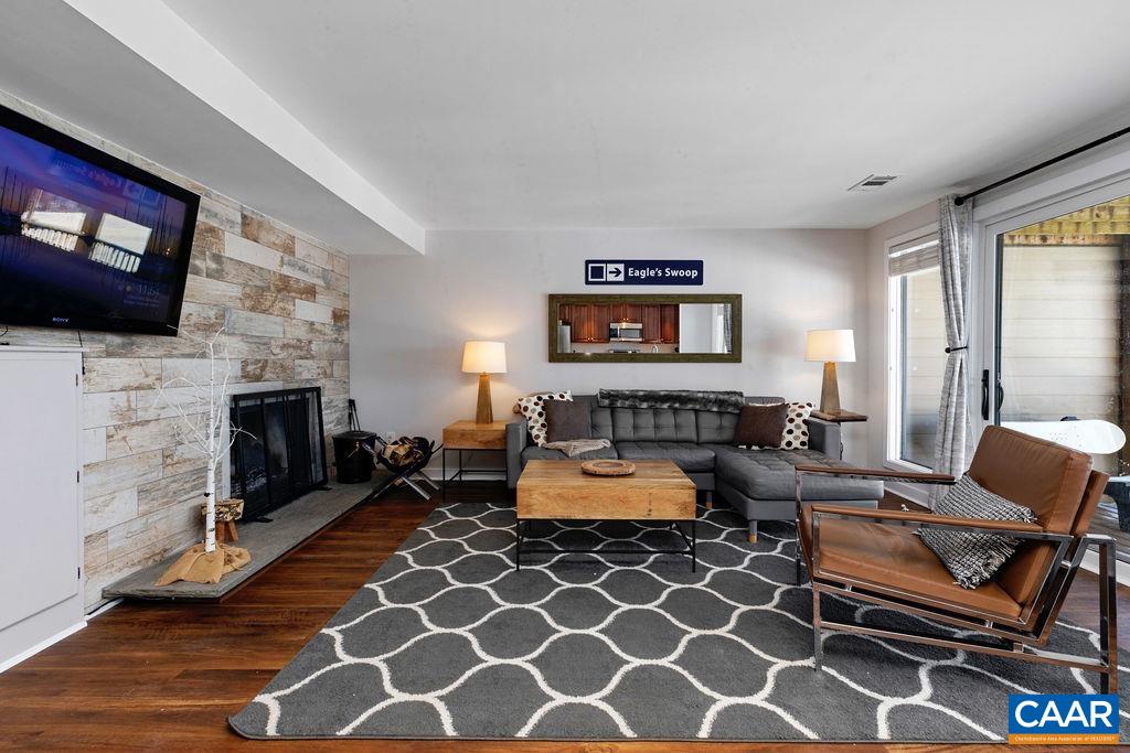 105 Eagles Court Wintergreen, VA 22967 - Photo 7 of 47 a living room with furniture a flat screen tv and a fireplace