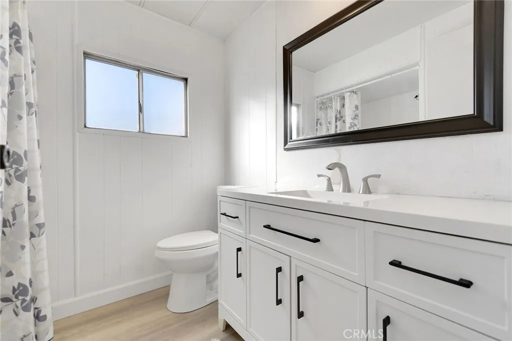 840 Foothill, Unit 27 Azusa, CA 91702 - Photo 25 of 30 a bathroom with a sink a toilet and mirror