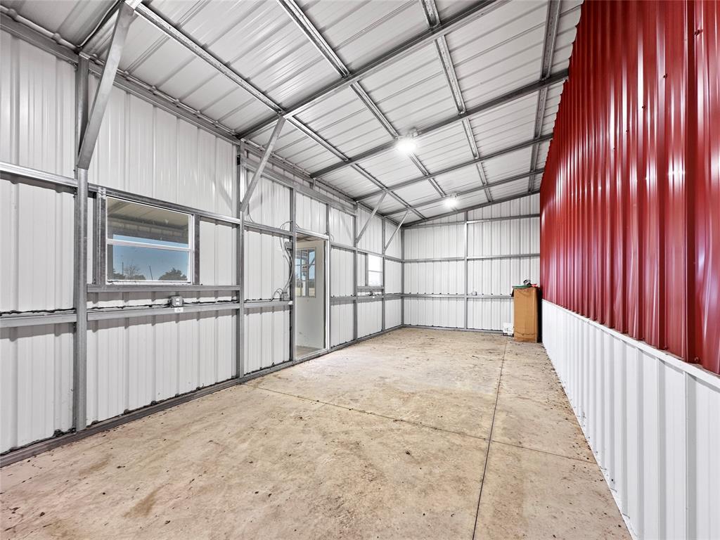501 County Road 501 Blue Ridge, TX 75424 - Photo 13 of 27 Enclosed tack room with metal-paneled walls, concrete flooring, electrical access, and a secure door, suitable for organized equipment and supply storage.