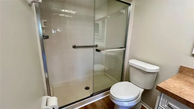 a white toilet sitting next to a bathroom sink