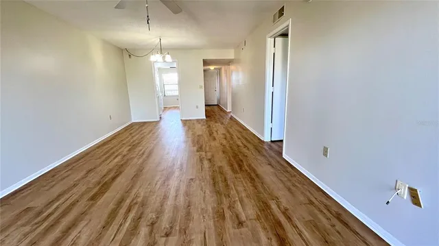 a view of a room with wooden floor and staircase