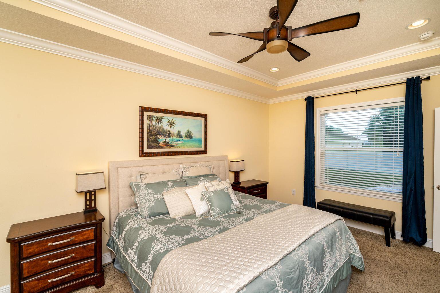 1026 Southwest Ingrassina Avenue Port St. Lucie, FL 34953 - Photo 12 of 20 a bedroom with a bed and a chandelier