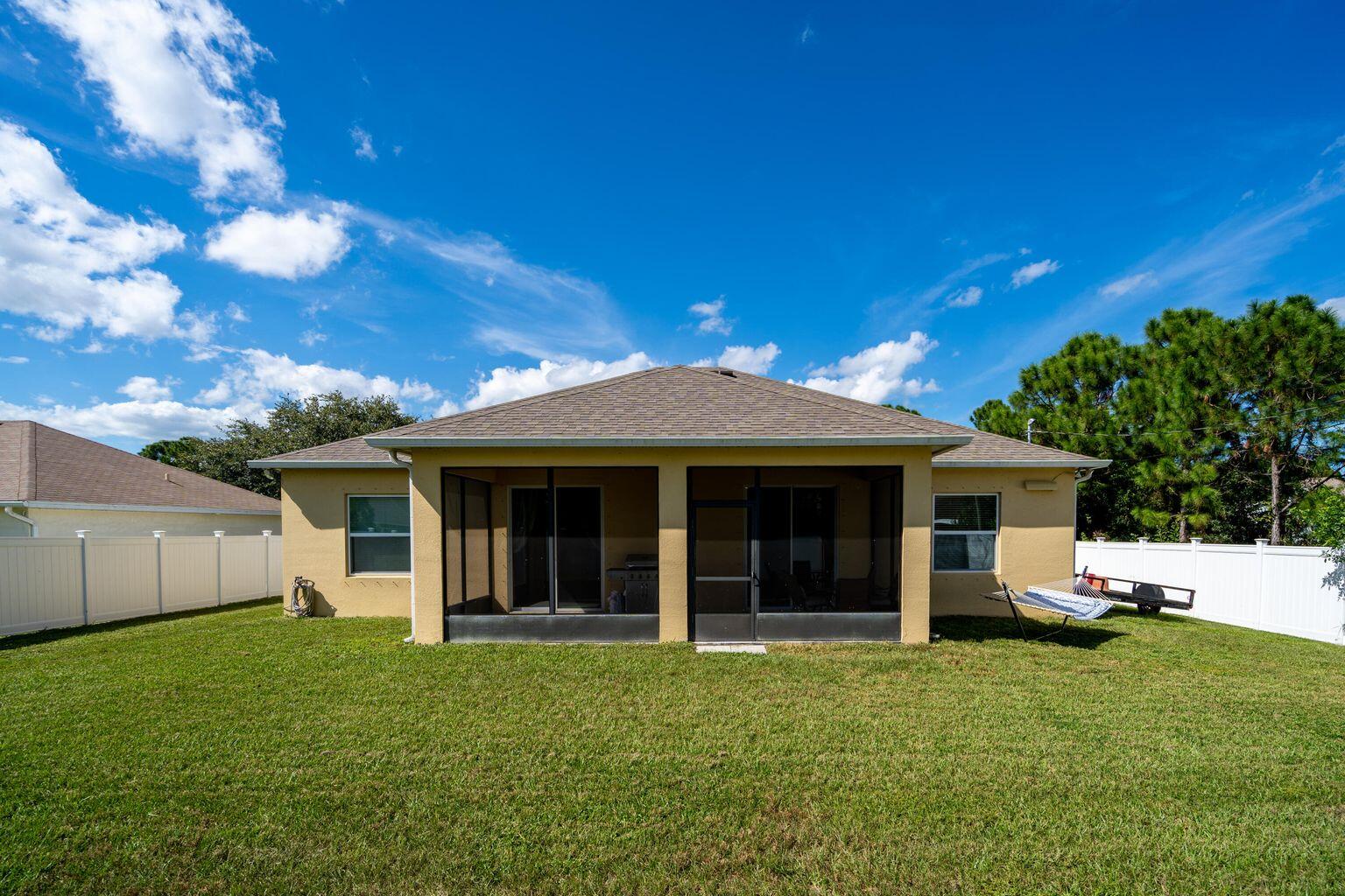1026 Southwest Ingrassina Avenue Port St. Lucie, FL 34953 - Photo 3 of 20 a view of a house with backyard porch and garden