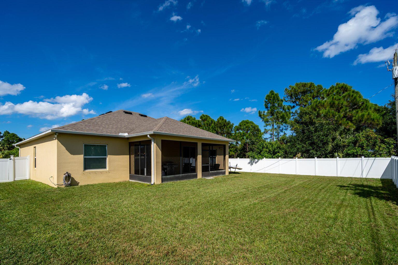 1026 Southwest Ingrassina Avenue Port St. Lucie, FL 34953 - Photo 4 of 20 a view of a house with a backyard