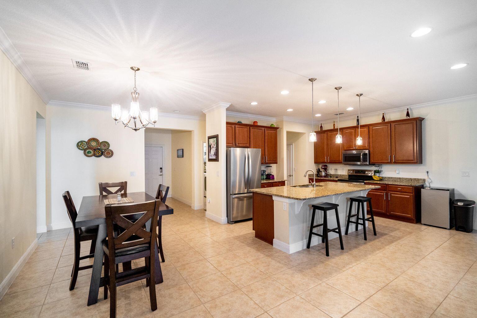 1026 Southwest Ingrassina Avenue Port St. Lucie, FL 34953 - Photo 9 of 20 a view of a dining room with furniture