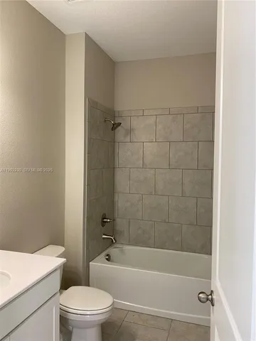 a bathroom with a toilet a sink and bathtub