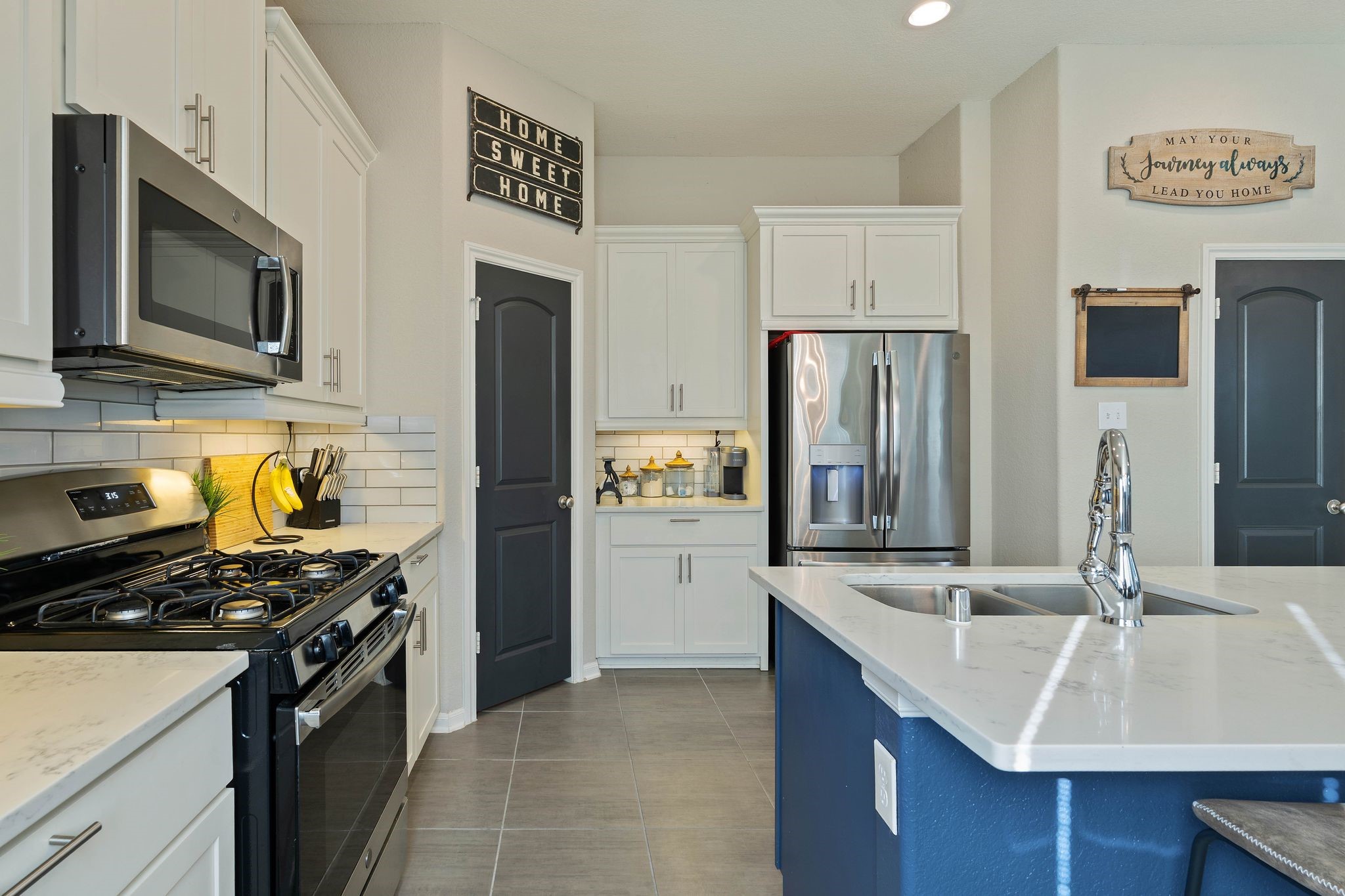 227 Biltmore Loop Montgomery, TX 77316 - Photo 11 of 33 a kitchen with stainless steel appliances granite countertop a sink stove and refrigerator