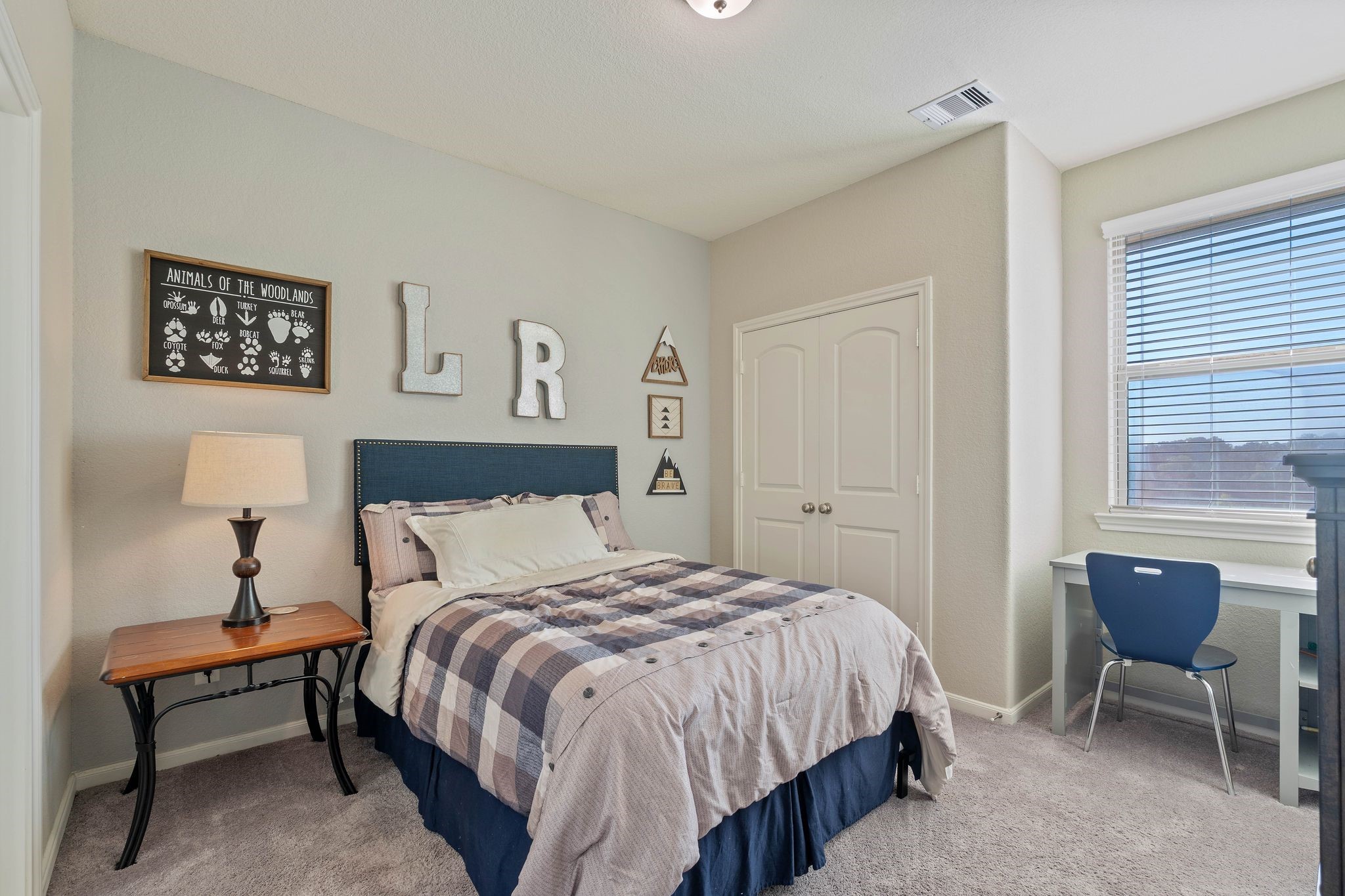 227 Biltmore Loop Montgomery, TX 77316 - Photo 12 of 25 a bedroom with a bed a table and chair