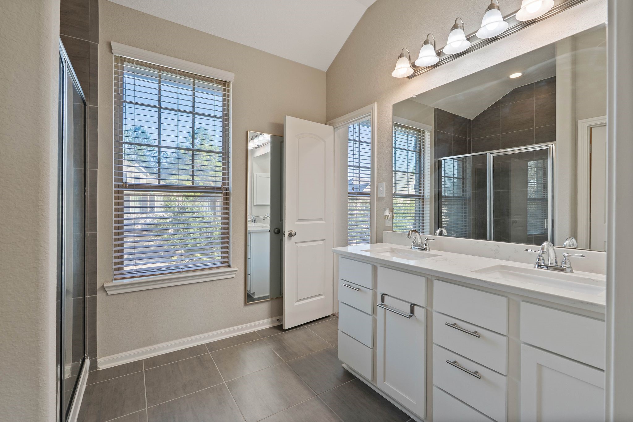227 Biltmore Loop Montgomery, TX 77316 - Photo 22 of 33 a bathroom with a sink double vanity and a mirror