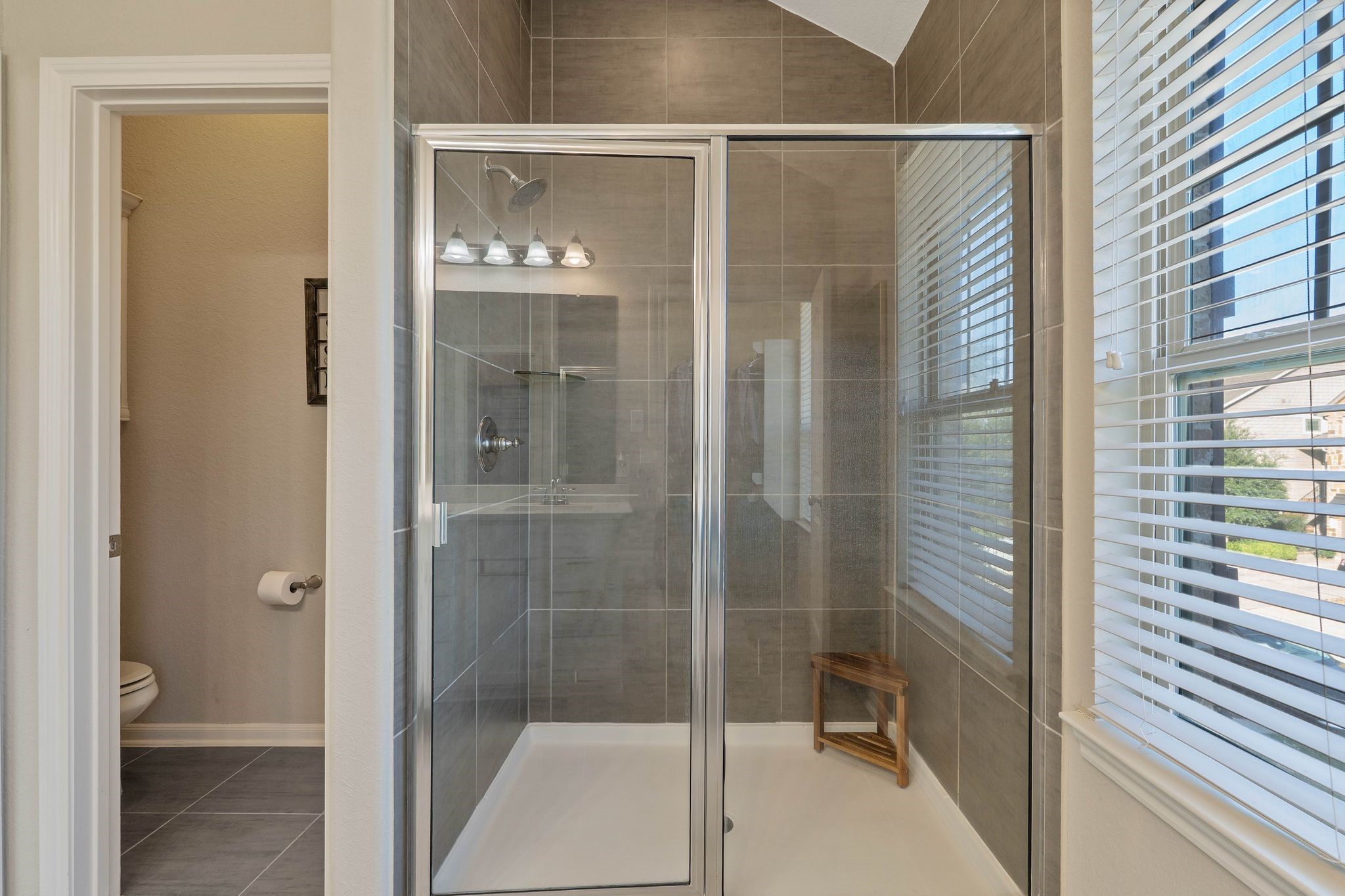 227 Biltmore Loop Montgomery, TX 77316 - Photo 24 of 33 a bathroom with a glass shower door