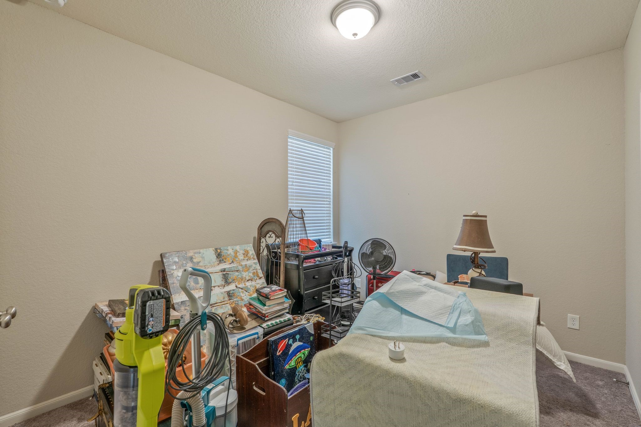 227 Biltmore Loop Montgomery, TX 77316 - Photo 26 of 33 a bedroom with a bed and a table