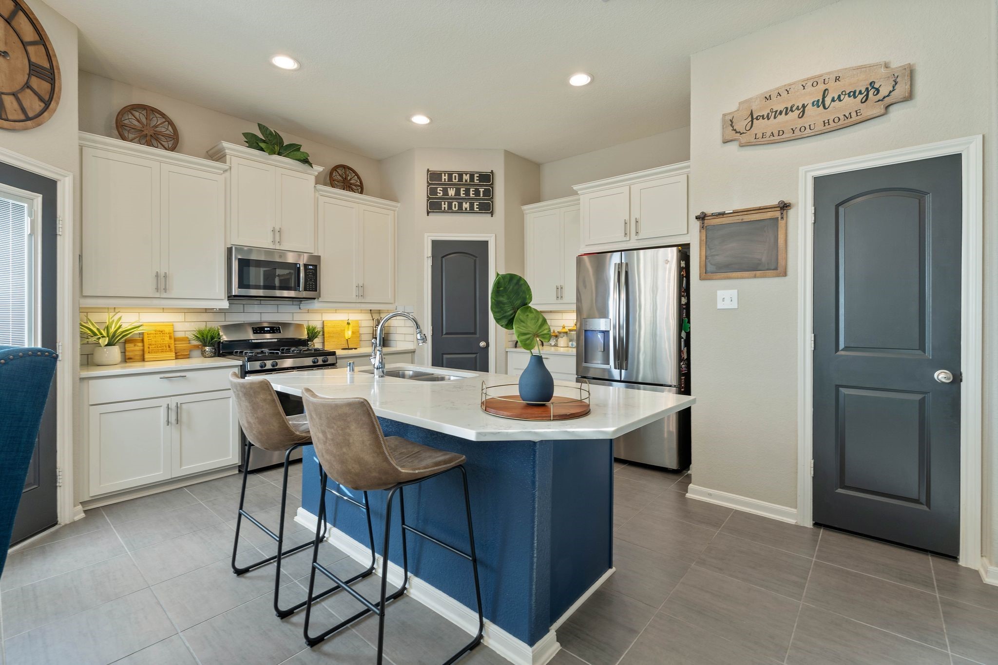 227 Biltmore Loop Montgomery, TX 77316 - Photo 6 of 25 a kitchen with refrigerator and cabinets