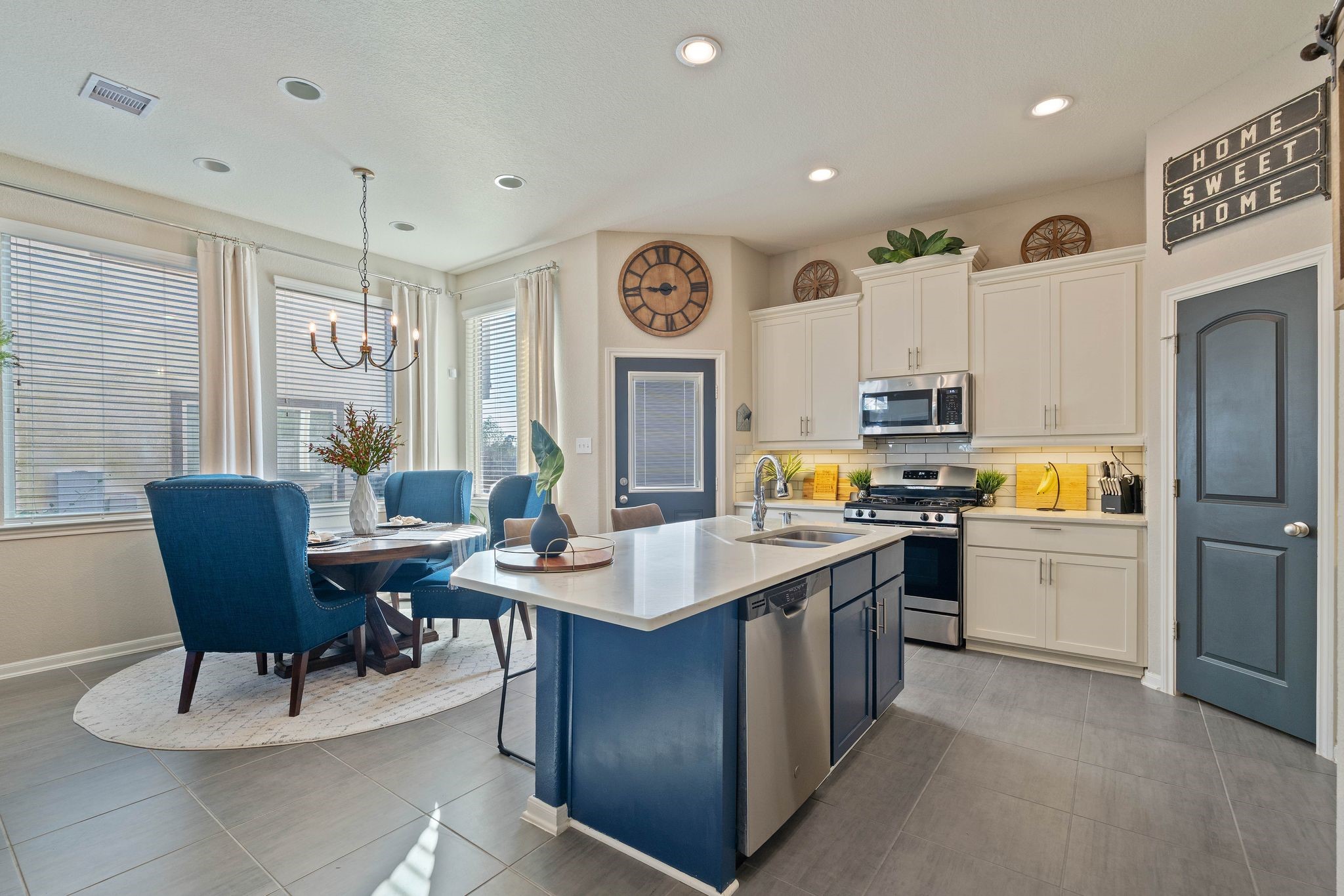227 Biltmore Loop Montgomery, TX 77316 - Photo 7 of 25 a kitchen with stainless steel appliances a table chairs and a refrigerator
