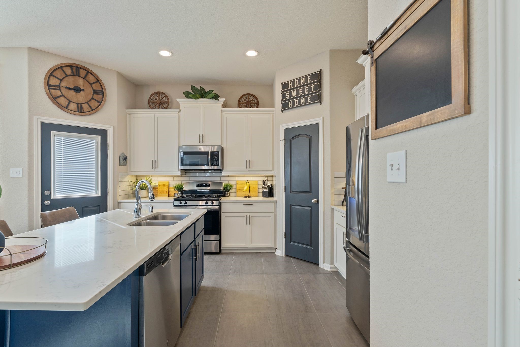 227 Biltmore Loop Montgomery, TX 77316 - Photo 9 of 33 a kitchen with white cabinets and stainless steel appliances